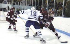 Yale forward Jeff Hristovski '06 prepares to check a Colgate defender in March 2003 at Ingalls Rink. Hristovski had an immediate impact on the men's ice hockey team last season as a freshman. The five new additions to the Eli squad this year will have a chance to make their own marks, as Yale lost five forwards at the end of last season.