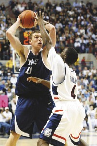 Huskie guard Ben Gordon gets in the face of Eli captain Matt Minoff '04 during a first round preseason National Invitational Tournament game Monday night at Gampel Pavilion in Storrs, Conn. The Bulldogs, who led 31-28 at the half, lost 70-60 to No. 1 UConn. Guard Edwin Draughan '05 and center Dominick Martin '05 led the Elis in scoring with 14 points apiece.