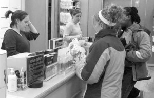 A customer buys clothes at the counter of the New Haven Gap on the corner of Chapel and Corner streets. The Gap, which is a tenant of Taft Realty Associates will be closing its doors forever on Jan. 26. The popular clothing store will not be offering any special sales in its final weekend.