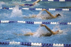 Yale swimmers Moira McCloskey ’07 (bottom) and Megan Bailey ’06 (top) corral a Brown swimmer (center) in a win over Brown at the Kiphuth Exhibition Pool Friday. The Bulldogs overcame a 25-point deficit to defeat the Bears. The win puts the Elis in a tie for fourth place in the Ivy standings.