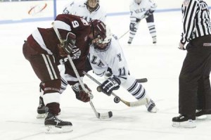 Forward Ryan Steeves ’04 tries to win a faceoff in the Elis’ Feb. 6 loss to Harvard. A combination of poor third period defensive play and several missed opportunities on the power play contributed to two Bulldog road losses this weekend. The Elis lost 4-2 to Vermont on Friday and 6-3 to Dartmouth on Saturday. With the two losses, the Elis can now gain neither a first round bye nor home-ice advantage in the ECAC playoffs.