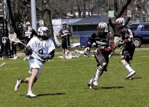 Bulldog midfielder David Schecter ’06 (No. 8) charges against a Brown Bear during Yale’s 12-11 loss on Saturday at Soccer-Lacrosse Stadium. Despite a late run in the fourth quarter, the Elis lost for the second time in a row by a single goal, dropping to a record of 1-3 in the Ivies.