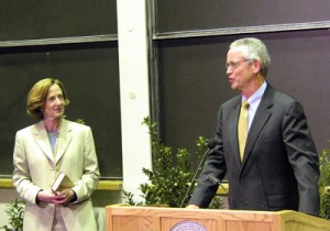 Provost Susan Hockfield (left), who will leave Yale in December to become president of the Massachusetts Institute of Technology, watches as outgoing MIT President Charles Vest speaks at a community meeting in Cambridge, Mass. Aug. 26. Vest gave Hockfield the book she is holding, which the president he succeeded gave him.