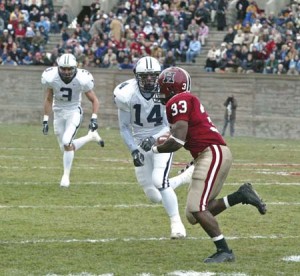 Harvard tailback Clifton Dawson looks to get past defensive end Don Smith ’05 and free safety Barton Simmons ’05 in The Game, Nov. 20 2004. Dawson ran for 120 yards and a touchdown in the Cantabs’ 35-3 rout of the Elis. The class of 2005 is the first in 82 years to fail to beat their rivals in four tries.