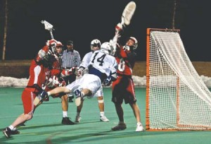 Attackman Seth Goldberg ’05 (14) gets airborne trying to find the back of the net against Hartford goalie Franklin Pargh (8). Goldberg and teammate Dan Brillman ’06, led the Bulldogs with four points apiece in the game. The 21-7 shellacking of the Hawks gives the team a much-needed boost heading into its game versus Princeton Saturday.