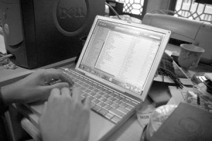A student listens to music files on his laptop. Despite recent crackdowns, many students continue to share files illegally.