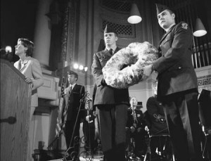 Students in military uniform hold a floral wreath at a Veteran’s Day concert in Woolsey Hall. Each program at the service printed the name of a different Yale alumnus who had died in service to his country.