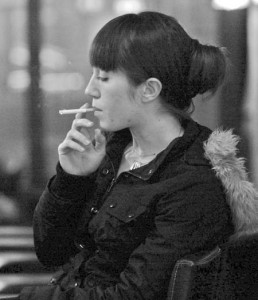 Erin Napolitano, an employee at Owl Shop, takes a break to enjoy a smoke. A recent study conducted at the School of Medicine indicates that some people may have a genetic predisposition to nicotine addiction.