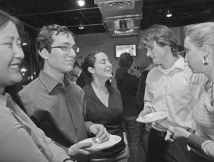 Rachel Plattus (center) meets with members of the New Haven Action Fund at Cafe Bottega on Wednesday night. NHA Fund officials have announced their intention to assemble the city’s student activists at a summit on March 3.