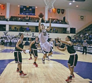 Caleb Holmes ’08 splits a group of Brown defenders and drives to the basket during the Bulldogs’ 76-71 loss to the Bears at John J. Lee on Jan. 20.