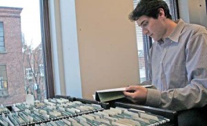 Light Fellowship assistant director Adam Ginsberg looks at files of fellowship applicants, who now have the chance to study in China through Greenberg Scholarships.