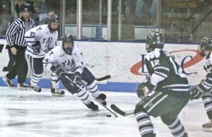 Greg Beller ’10 looks on as forward Mike Karwoski ’09 puts the moves on Dartmouth defenders during the Bulldogs’ 3-2 loss on Feb. 18.