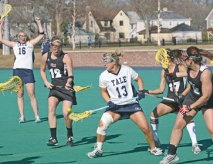 Midfielder Taylor Fragapane ’09 takes care of the ball while surrounded by UMass defenders during yesterday’s contest at Johnson Field. Fragapane notched a second-half goal in the Elis’ 13-9 victory.