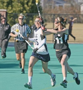 Midfielder Sara Greenberg ’09 carries the ball upfield as she tries to fend off a University of Massachusetts defender on March 28. This past Saturday, the women’s lacrosse team upset Princeton, keeping its Ivy title hopes alive.