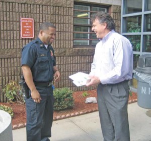 Ward 22 candidate and corrections officer Reggie Lytle, left, speaks with a warden at the Whalley Avenue Jail. The Ward 22 aldermanic election is today.