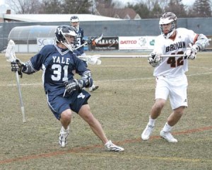 Midfielder Ben Fuchs ’07 dodges a check from a Brown defender during the men’s lacrosse team’s 10-9 loss to Brown in Providence, R.I. Yesterday, the Bulldogs rebounded from a string of recent losses to claim an 18-5 victory over Manhattan College at Reese Stadium, but the Elis remain winless in league play.