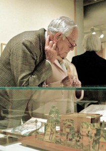 Yale Center for British Art museumgoers look over a display in an exhibition honoring founder Paul Mellon ’29.