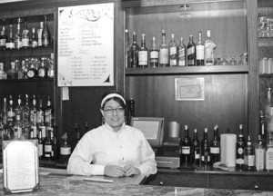 A waitress works the bar at Quattro, one of 15 local restaurants participating in a fundraising project to fight AIDS called Dining Out for Life.
