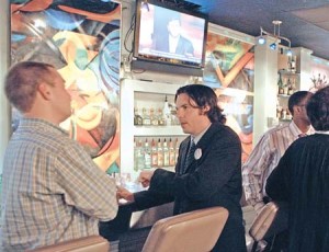 New Haven residents mingle at Nikkita and watch the Democratic presidental hopefuls in the first primary-season debate.
