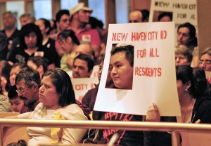 New Haven residents show their support for a proposed municipal ID program at City Hall on Thursday. The program would offer a form of identification to all residents, including illegal immigrants.