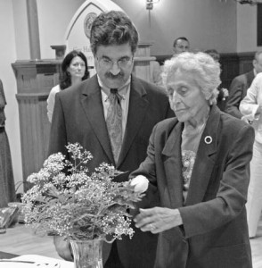 A Holocaust survivor places a rose during a ceremony at New Haven’s City Hall on Thursday. The New Haven Holocaust Memorial is now 30 years old.