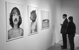 Visitors observe a few of the paintings up for auction at Artspace last year. This year’s Gala Benefit Auction will be held on Saturday evening.