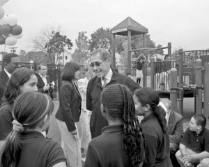 Murray Lender talks to kids Wednesday after the dedication of a playground on the site where the Lender family started its bagel brand.