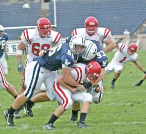 The Cornell rusher is going nowhere after Yale DE Justin Oplinger ’10 and DL Kirk Porter ’08 bring him down during the Elis’ 51-12 rout at home last weekend.