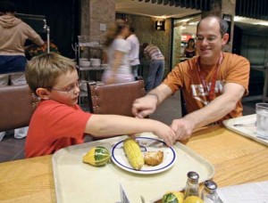 Morse College Dean Joel Silverman eats dinner with his son Noah in the Morse dining hall while surrounded by hundreds of dining undergraduates.