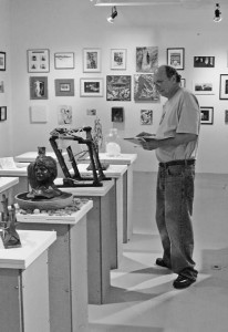 A visitor peruses works by local artists at Artspace, a nonprofit gallery. Additional artowrk will be shown in storefronts in Ninth Square and the Lot, another gallery.