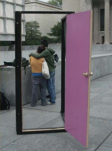 Two students stand close to the symbolic doors set up on Beinecke Plaza, through which students walked to mark National Coming Out Day.