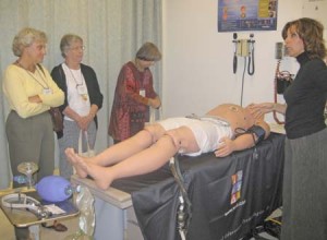 A patient robot, which nursing students use to simulate treating wounds and injuries, is presented at the Nursing School’s Alumni Weekend.