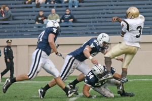 With a group of teammates in tow, defender Kyle Hawari ’09 takes down Lehigh quarterback Sedale Threatt on Oct. 13.