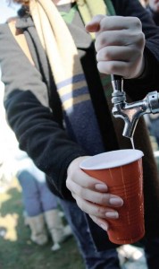 A student taps a keg at a previous Harvard-Yale tailgate. This year, students may be prohibited from bringing U-Hauls onto tailgate grounds.