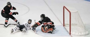 Forward Broc Little ’09 slides into Princeton goalie Alan Reynolds during the Elis’ 6-2 defeat Friday night. Five Tiger goals in the second period gave Reynolds all the room he needed in the game’s late minutes.