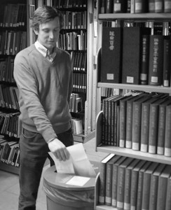 Librarian Jerry Little puts paper in a recycling bin. The University has recently implemented plans to increase the percentage of waste that is recycled here.