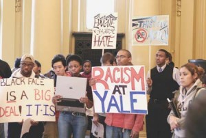 Students protest at Wednesday’s “Rally Against Hate” in Woolsey Hall, which was followed by a nighttime vigil on Cross Campus.