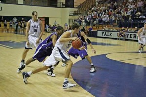 Caleb Holmes ’08 drives the lane following a Matt Kyle ’08 pick against Holy Cross in a game last season. The pair leads the team in scoring through two games.