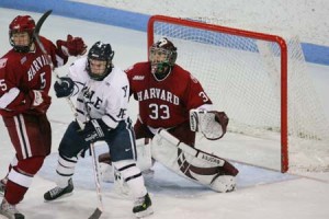 Forward Sean Backman ‘10 wards off a Harvard defender last night at Ingalls Rink. The Bulldogs tied No. 15 Crimson, 3-3, in overtime. to earn a point in the ECAC.