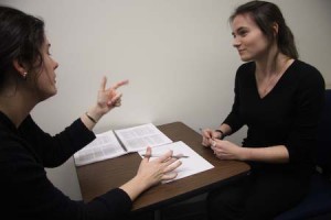 aura Morris ’09, right, discusses a paper with another student at the Writing Center. The Center may recruit additional tutors to meet rising demand.