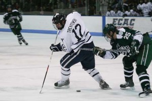 Defender Ken Trentowski ’11 tries to control the puck against the Big Green last week. The Elis won 6-3. Yale will take on Quinnipiac and Princeton on the road Friday and Saturday, respectively.