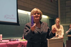 Patty Brisben, founder and CEO of Pure Romance, speaks at Davies Auditorium on Tuesday night. Brisben’s team, with pink feathers and vibrators on hand, discussed the power of “intimacy-enhancing products.”