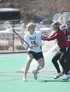 Lauren Taylor ’08 looks to make a pass during a 14-6 win over Harvard on Saturday. The captain finished with 3 goals and 2 assists as the Elis put the brakes on a surging Crimson team that had one prior loss.