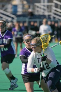 Attacker Meredith Callahan ’08, who led the team with four assists, moves past a Holy Cross player yesterday at Johnson Field. The Elis beat the Crusaders, 19-9.