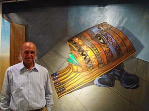 Formerly Saddam Hussein’s plastic surgeon, Ali Bashir stands in front of “Decorated Mask With Boot,” done in 2003 in Qatar, 3 x 4 meters, oil on Belgian linen.