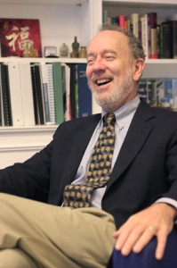 In his office, Brenzel sifts through admissions files and other paperwork. He has also served as a Jesuit novice and earned a doctorate in philosophy.