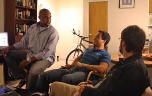 Chris Bartley ’04, left, Jason Park ’04 and Alex McBurney ’04 meet in their apartment. They, along with Jon Sela ’04, are the cofounders of a graphics-based networking site.
