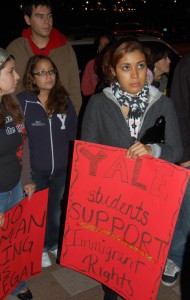 Students stand outside City Hall on Tuesday evening to express support for the Elm City Resident Card. Aldermen voted to accept $150,000 in private money to fund the second year of the card.