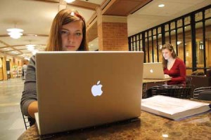 Two students use Bass Library’s Macs. While many Yale students expressed fondness for Macs, most do not plan to run right out and buy one of the new laptops.