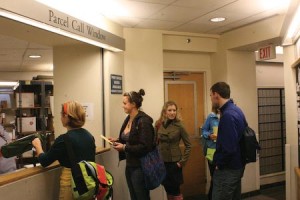 Students wait at Yale Station’s Parcel Call Window, yellow slips in hand, to pick up packages. Line lengths vary.